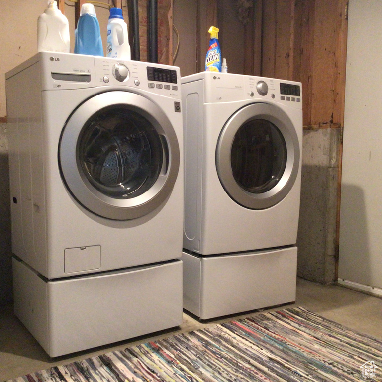 Clothes washing area featuring washer and dryer and laundry area