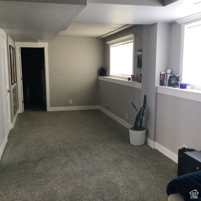 Unfurnished bedroom with carpet flooring and baseboards