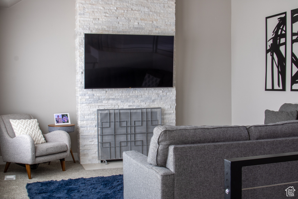 Interior space featuring a stone fireplace and carpet