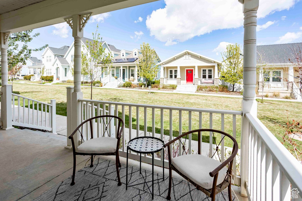 Balcony featuring covered porch and a residential view