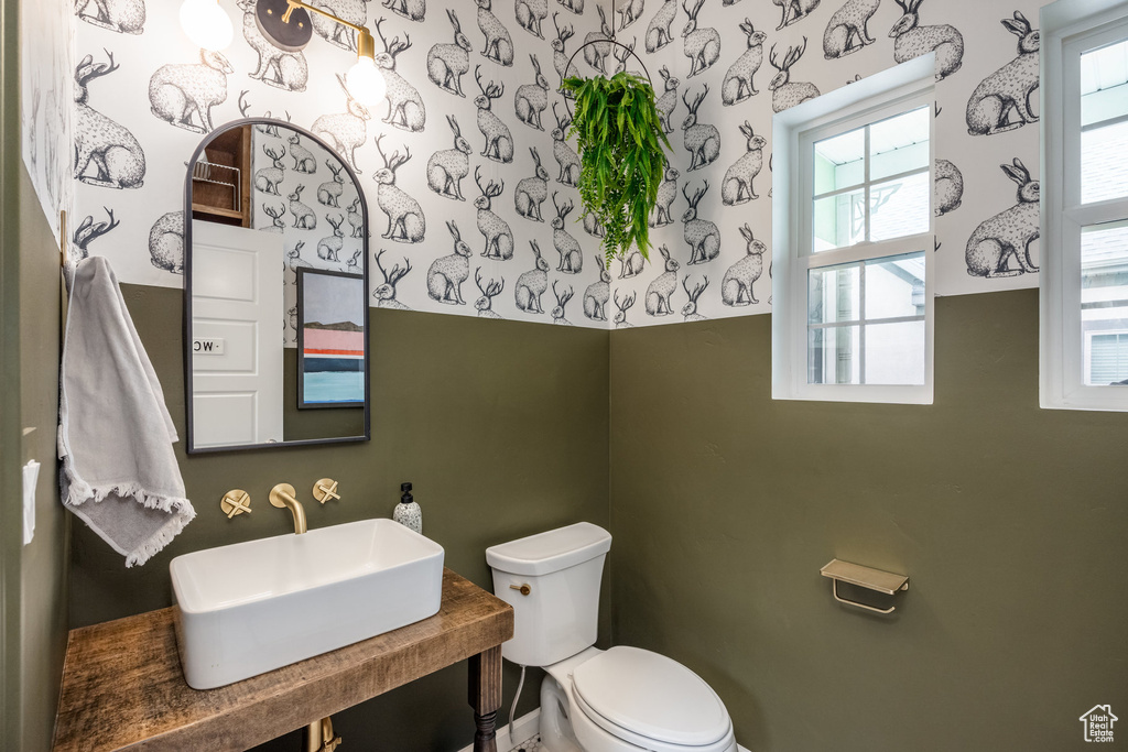 Half bathroom with a sink and toilet