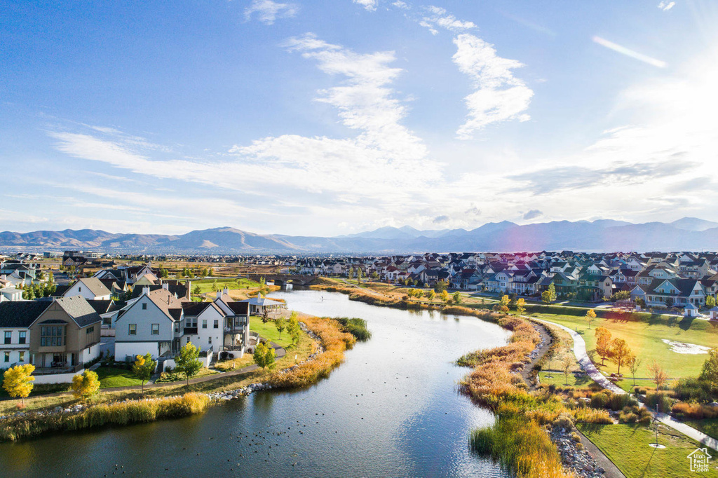 Drone / aerial view featuring a water and mountain view and a residential view