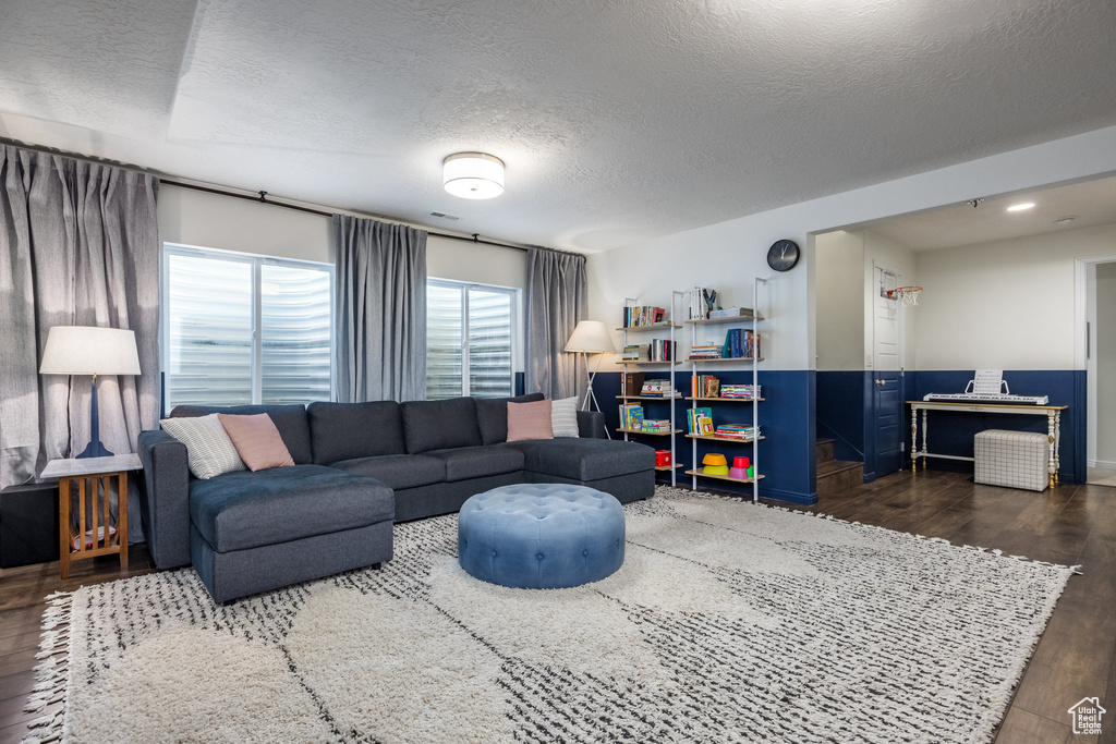 Living area with wood finished floors and a textured ceiling