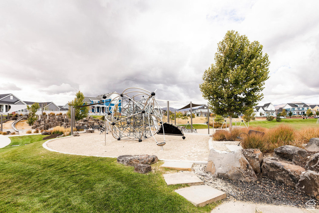 Community jungle gym with a yard and a residential view