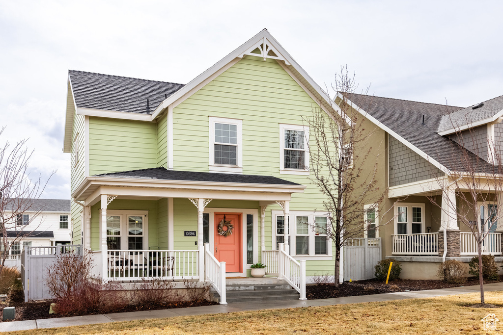View of front of property with a porch and a shingled roof