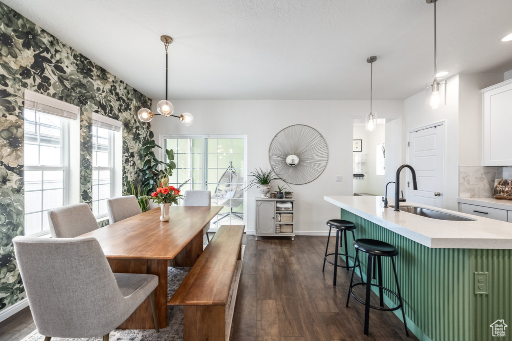 Dining space with dark wood finished floors and baseboards