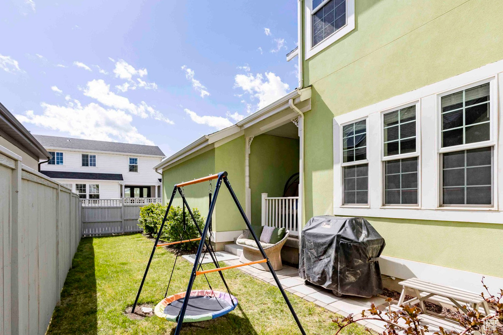 Exterior space featuring a fenced backyard and a grill