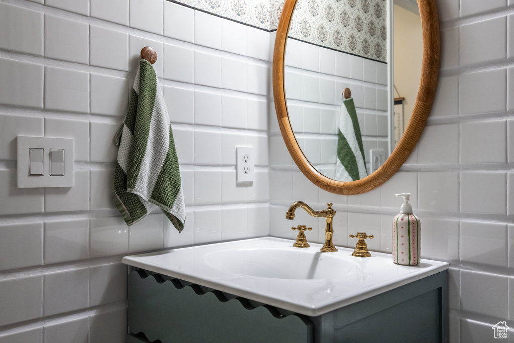 Bathroom featuring tile walls and vanity
