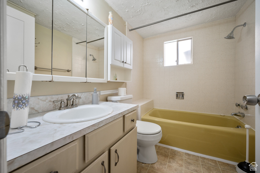 Full bath featuring vanity, shower / bathing tub combination, toilet, and a textured ceiling
