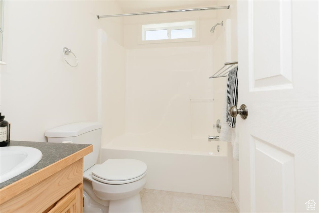 Bathroom featuring vanity, shower / bathtub combination, and tile patterned floors