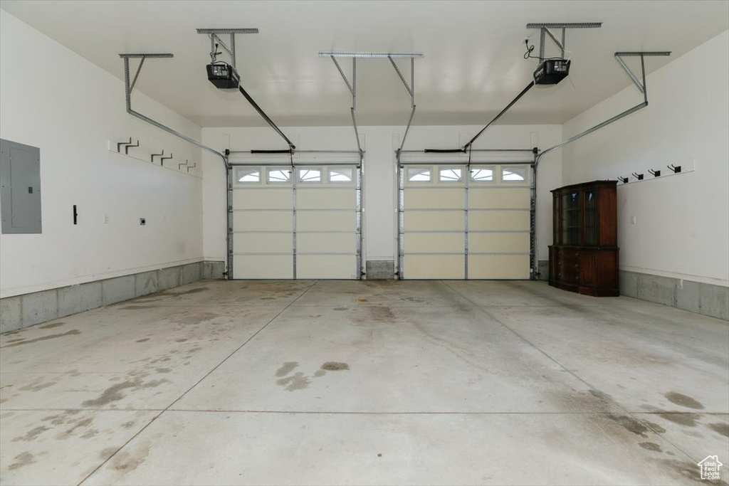 Garage with electric panel and a garage door opener