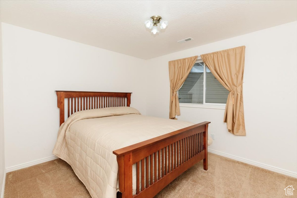 Bedroom featuring carpet flooring and baseboards