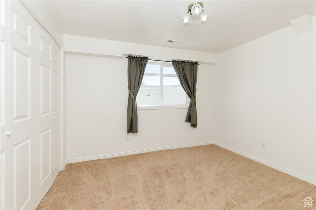 Empty room featuring carpet flooring