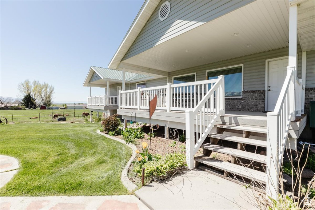 View of home's exterior with a yard and a wooden deck