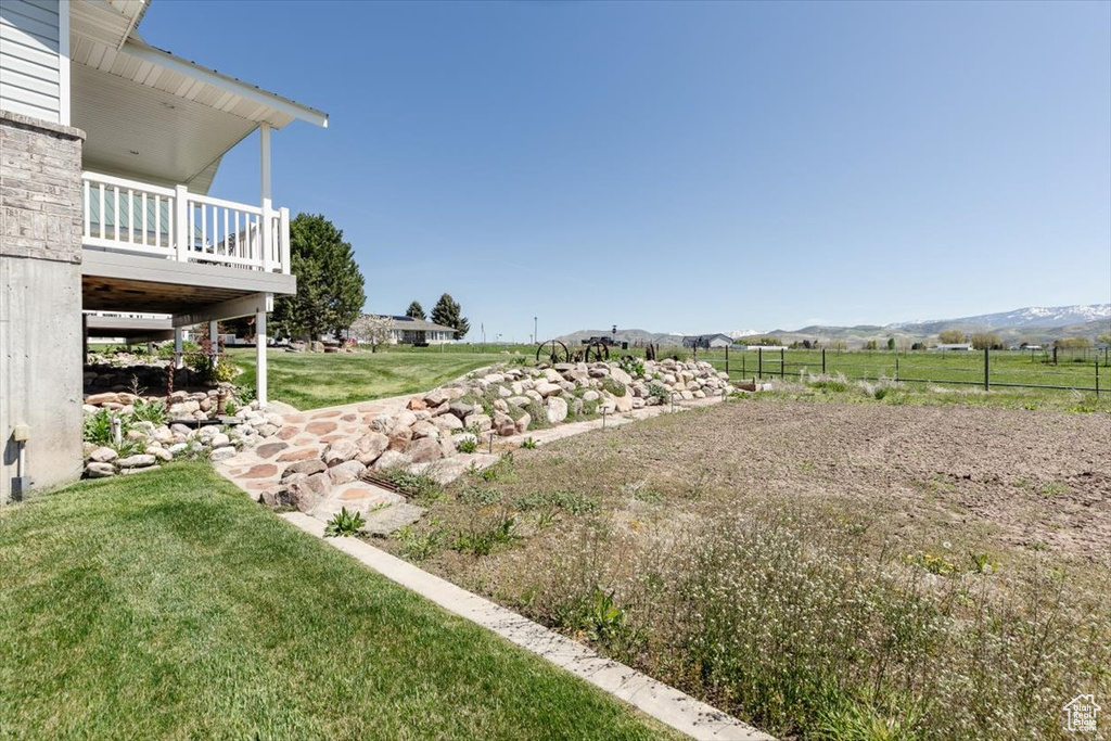 View of grassy yard featuring a mountain view