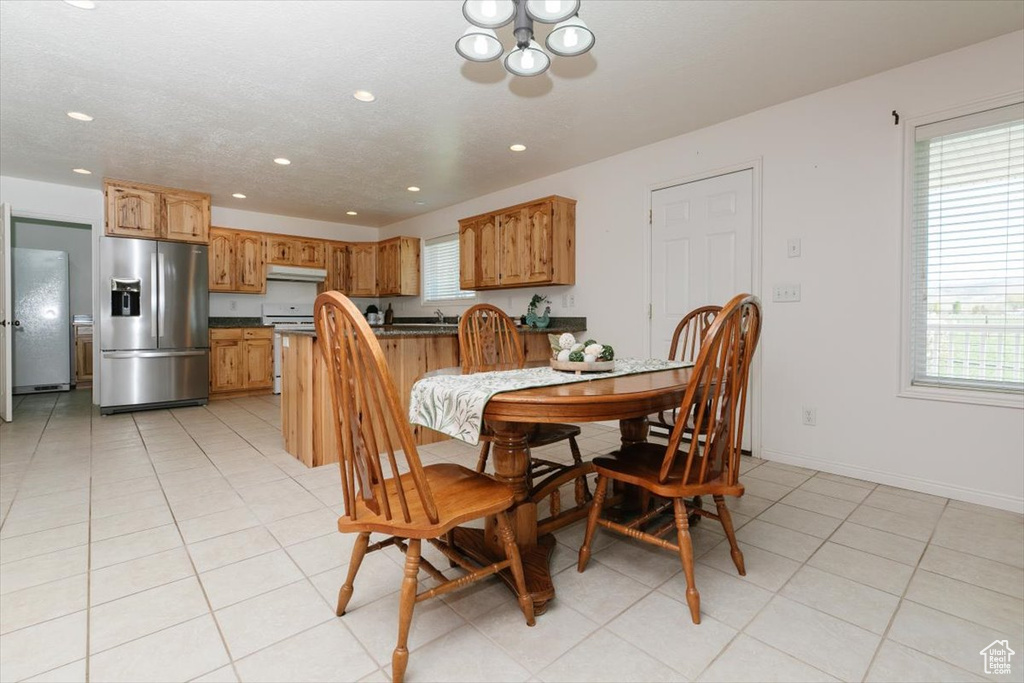 Dining space with recessed lighting, a chandelier, and light tile patterned flooring