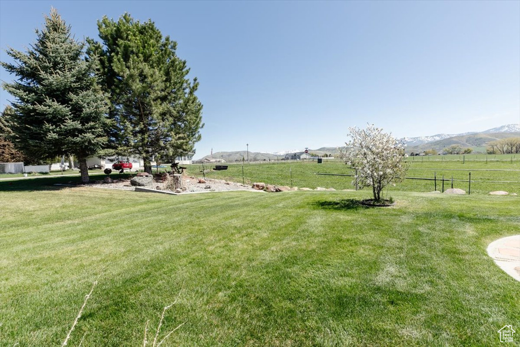 View of yard featuring a rural view and a mountain view