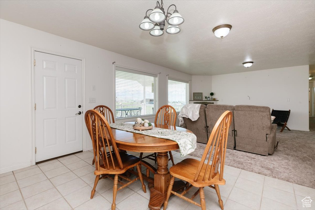 Dining room featuring a chandelier and light tile patterned floors