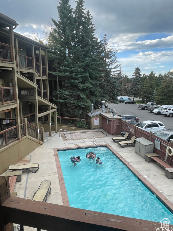 Community pool featuring a patio