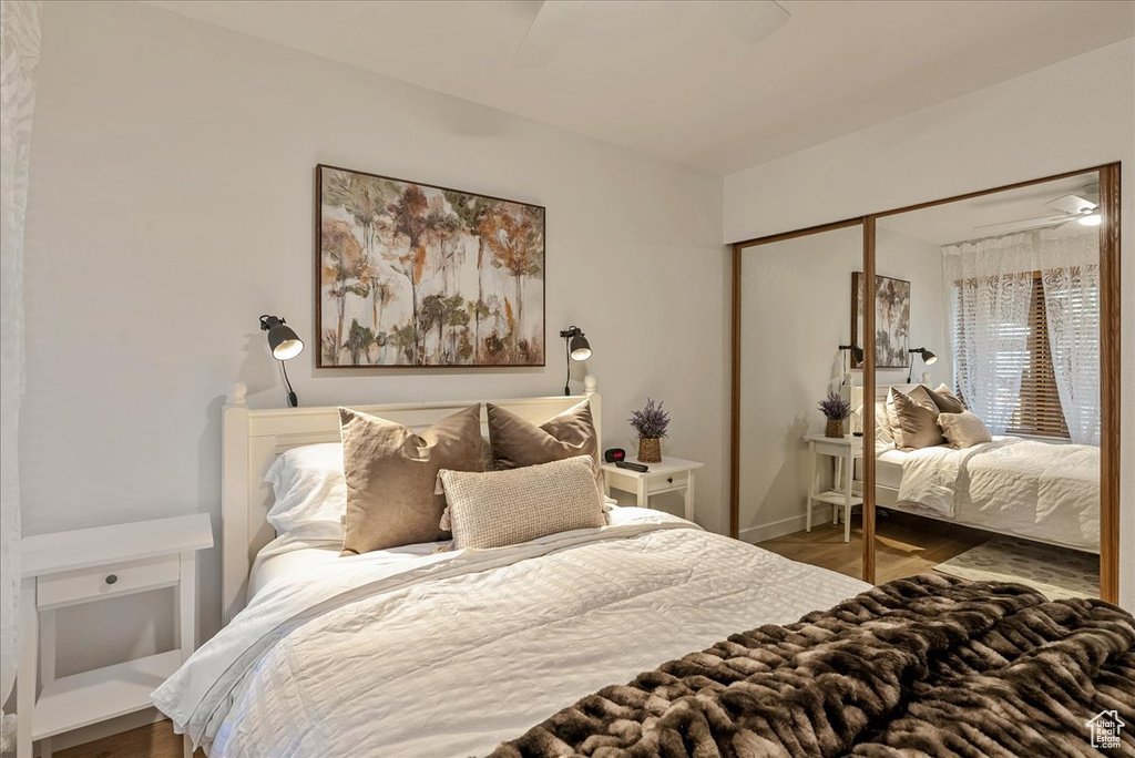 Bedroom featuring baseboards, a ceiling fan, wood finished floors, and a closet