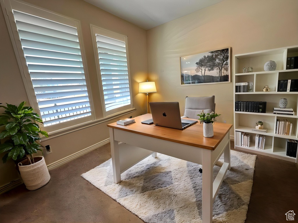 Carpeted office space featuring baseboards