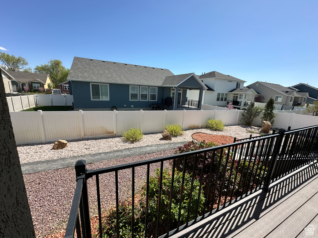 Exterior space with a fenced backyard and a residential view