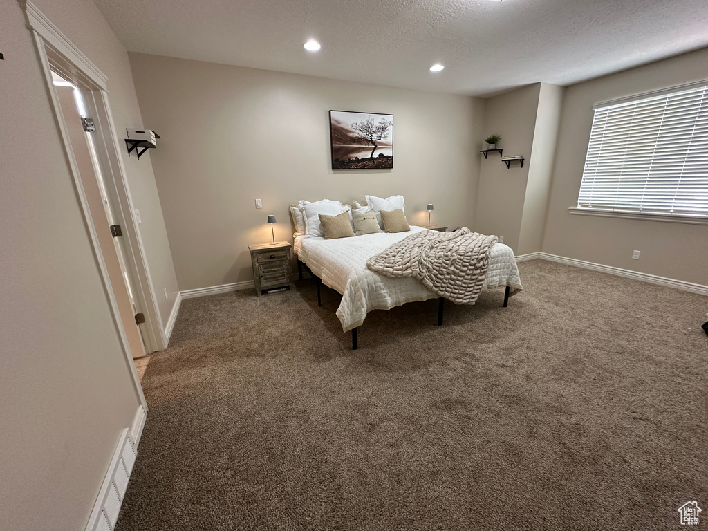 Bedroom featuring recessed lighting, carpet, and baseboards
