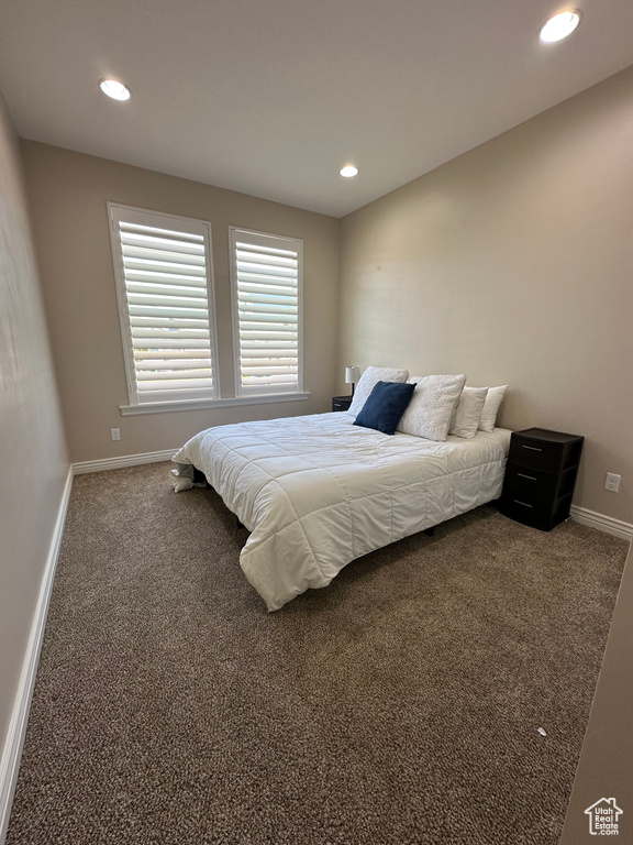 Carpeted bedroom with baseboards and recessed lighting