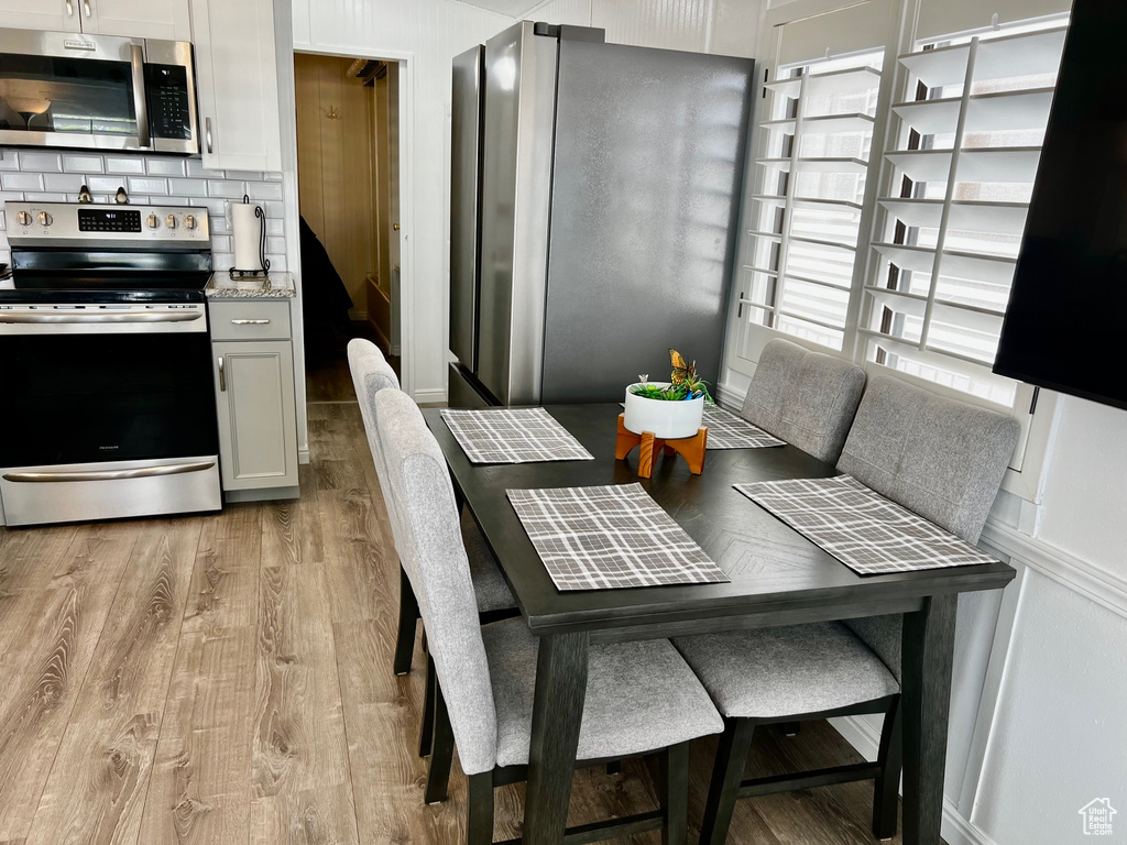 Dining space with light wood-style flooring