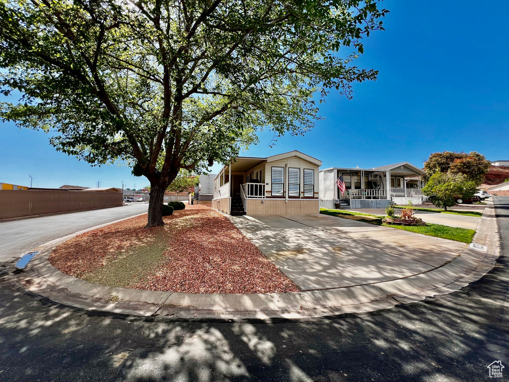 View of front of home with driveway and covered porch