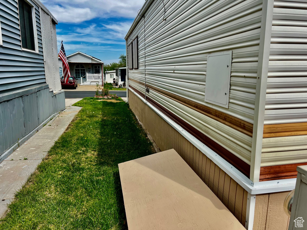 View of side of home with a yard