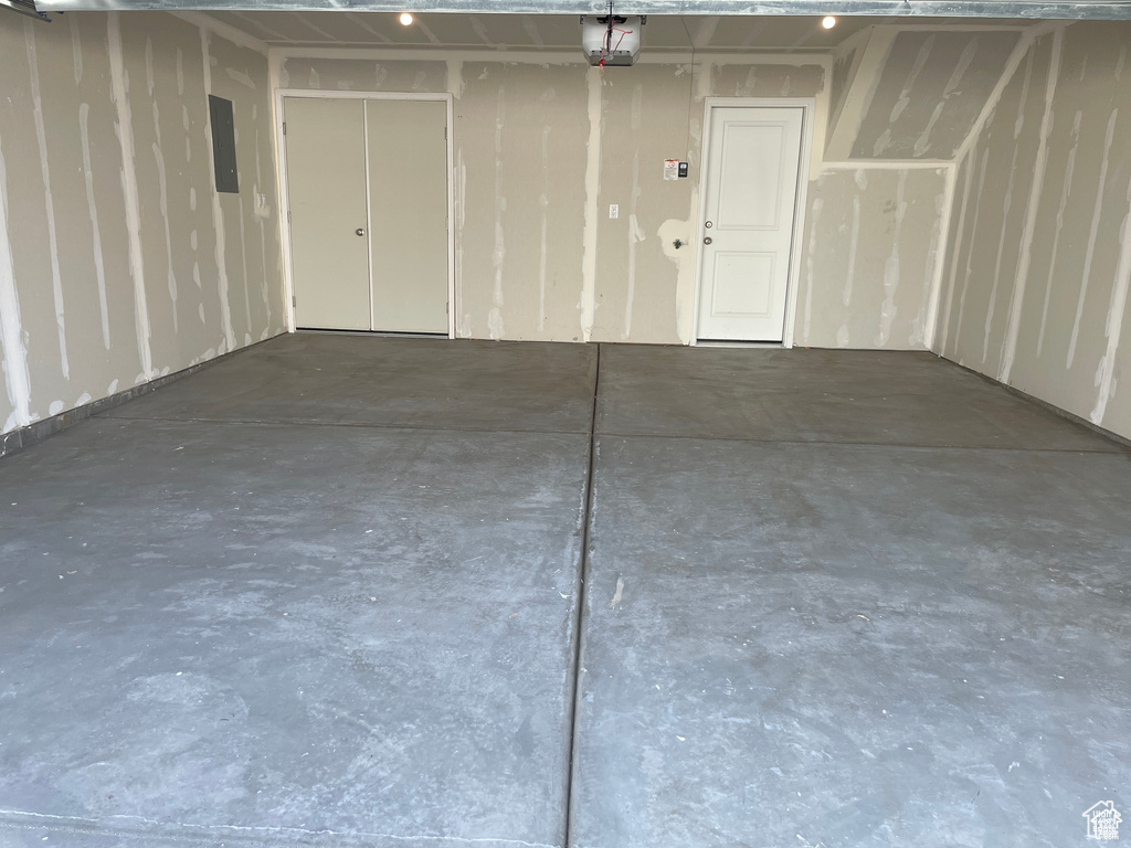 Garage with electric panel and a garage door opener