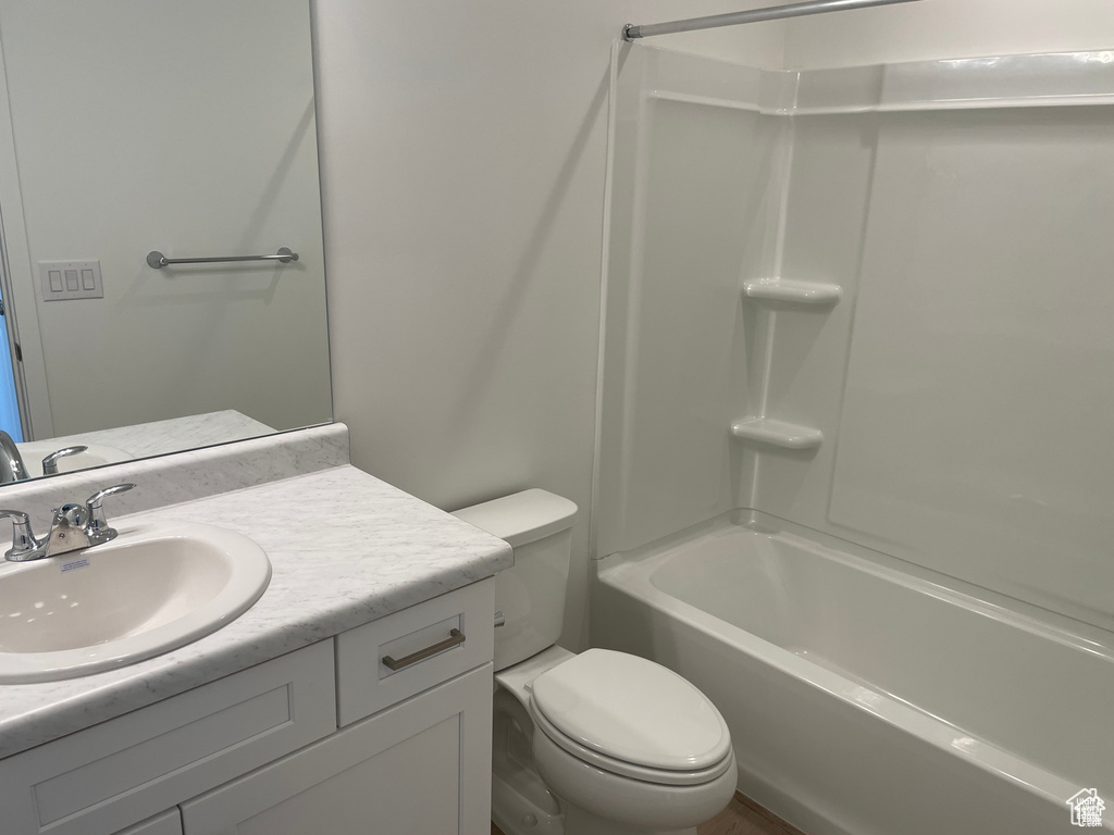 Full bathroom featuring toilet, vanity, and bathtub / shower combination