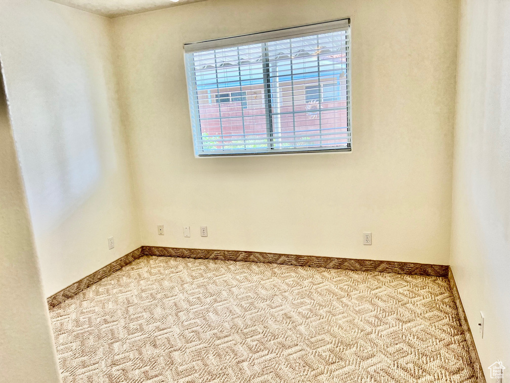 Carpeted spare room with healthy amount of natural light