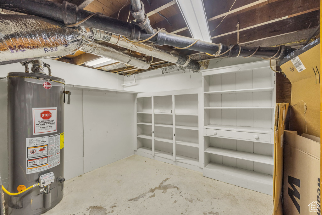 Unfinished below grade area featuring gas water heater