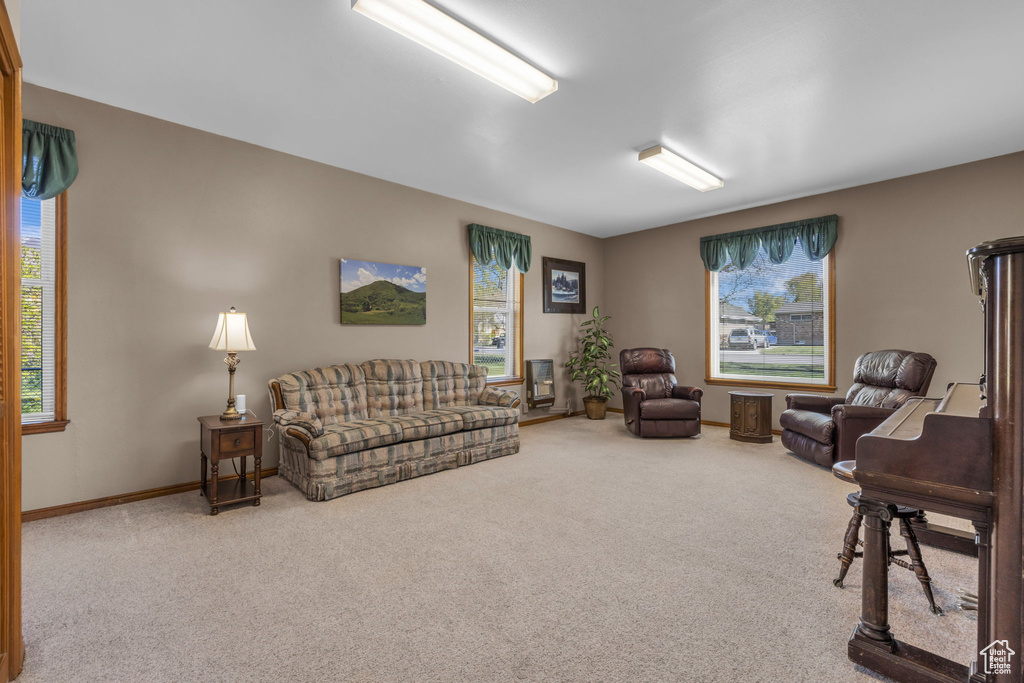 Living room with a wealth of natural light, carpet flooring, and baseboards