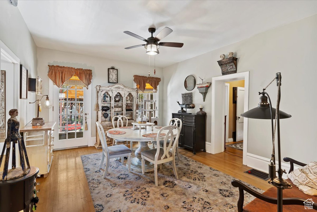 Dining area with plenty of natural light, ceiling fan, and wood-type flooring