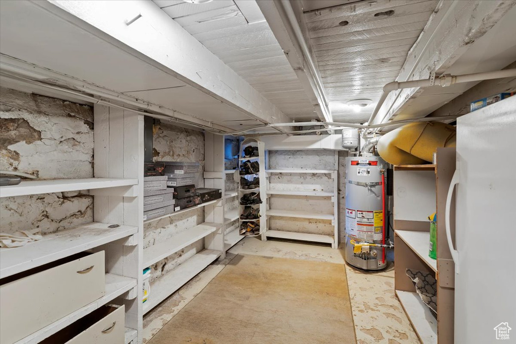 Unfinished basement featuring gas water heater