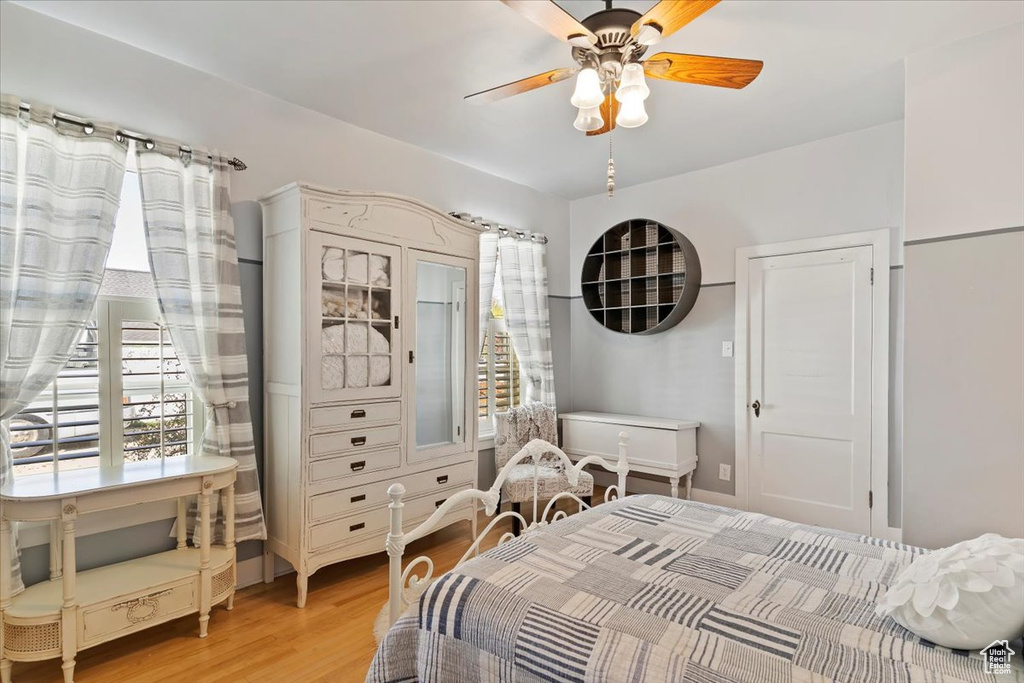 Bedroom with light wood finished floors and a ceiling fan
