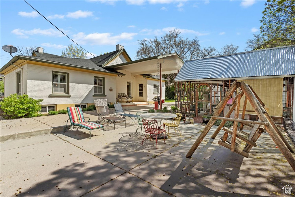 Rear view of property featuring a patio area