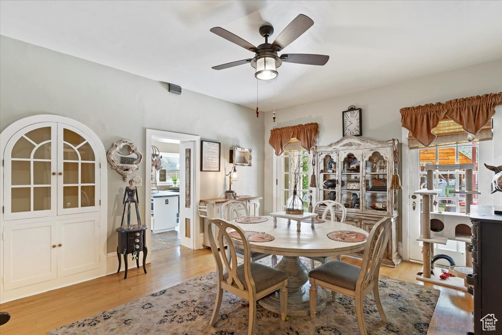 Dining space with ceiling fan and light wood finished floors