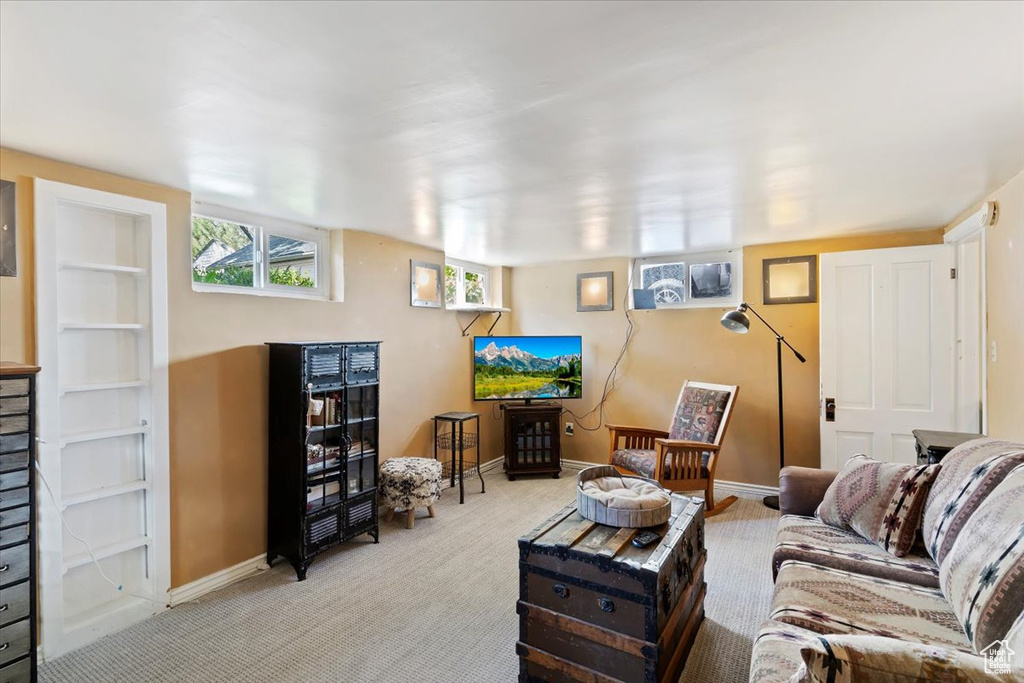 Carpeted living area featuring baseboards