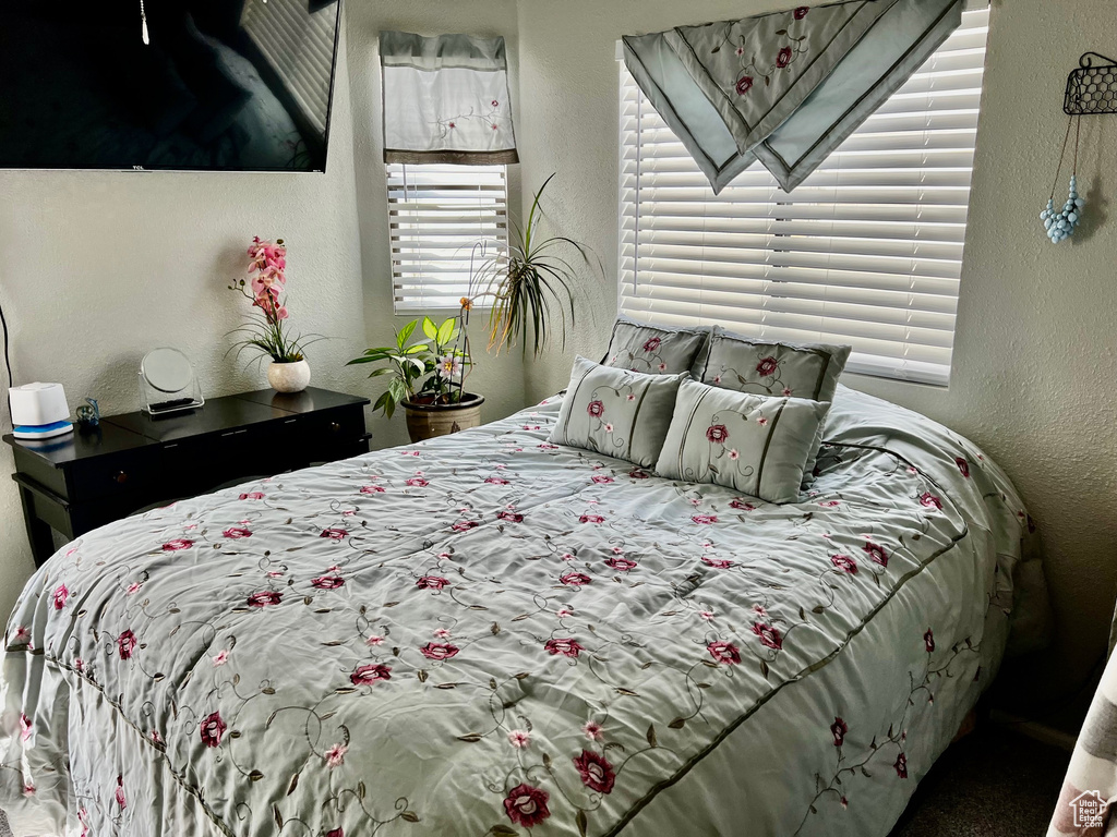 Bedroom featuring a textured wall