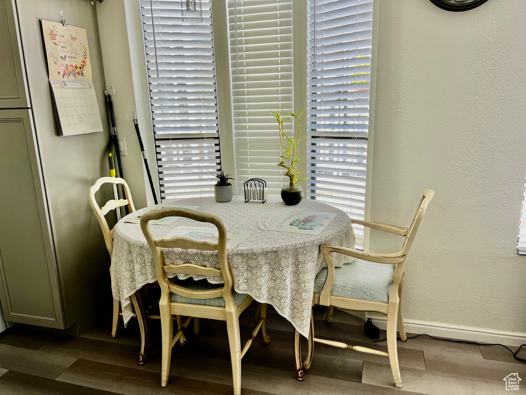 Dining area with baseboards, wood finished floors, and plenty of natural light