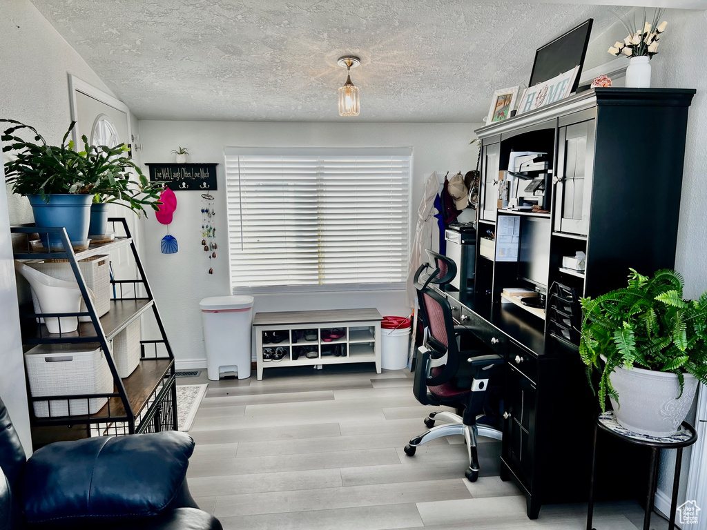 Office area featuring wood finished floors and a textured ceiling