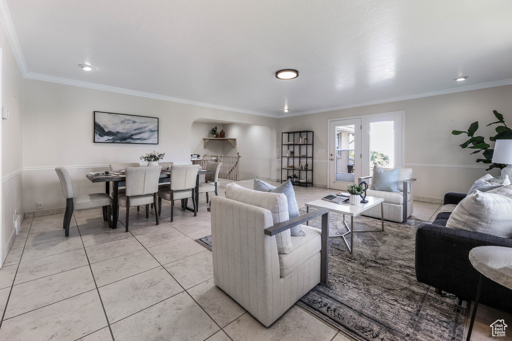 Living room with light tile patterned floors, baseboards, and ornamental molding