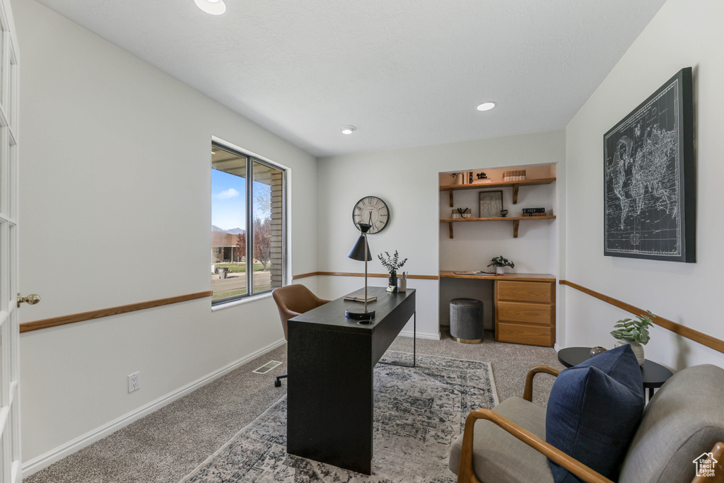 Office space with light carpet, baseboards, and recessed lighting