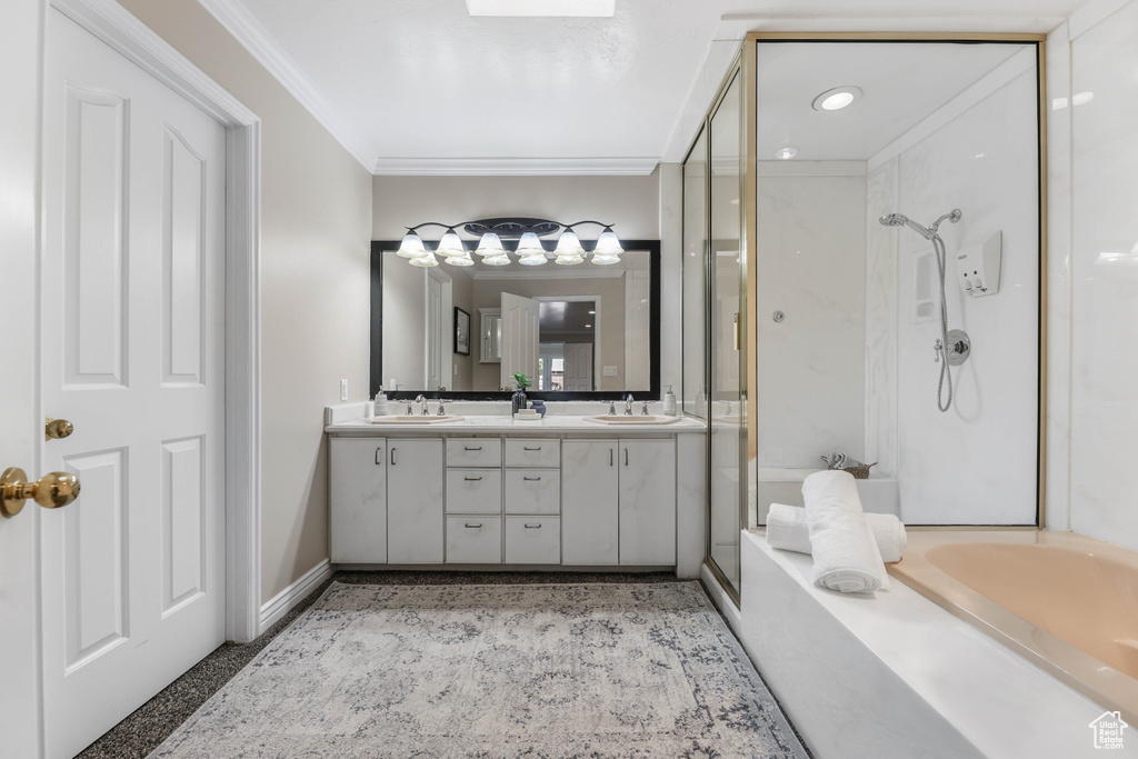 Full bath featuring a shower stall, ornamental molding, and a sink
