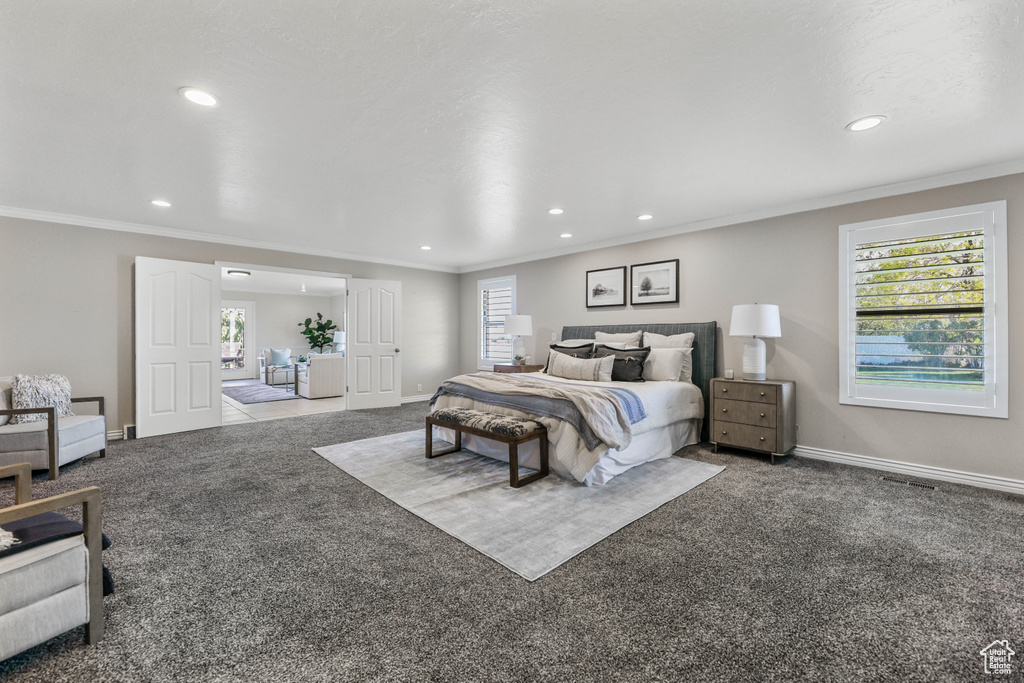 Bedroom featuring recessed lighting, carpet flooring, and multiple windows