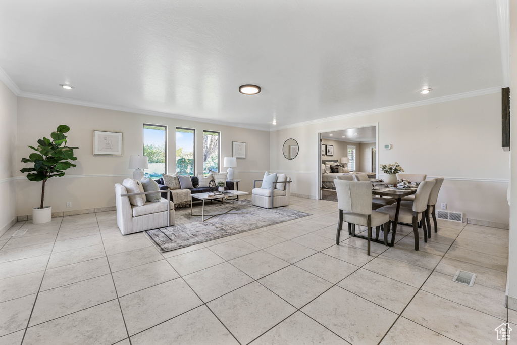 Living room featuring ornamental molding, visible vents, and light tile patterned floors